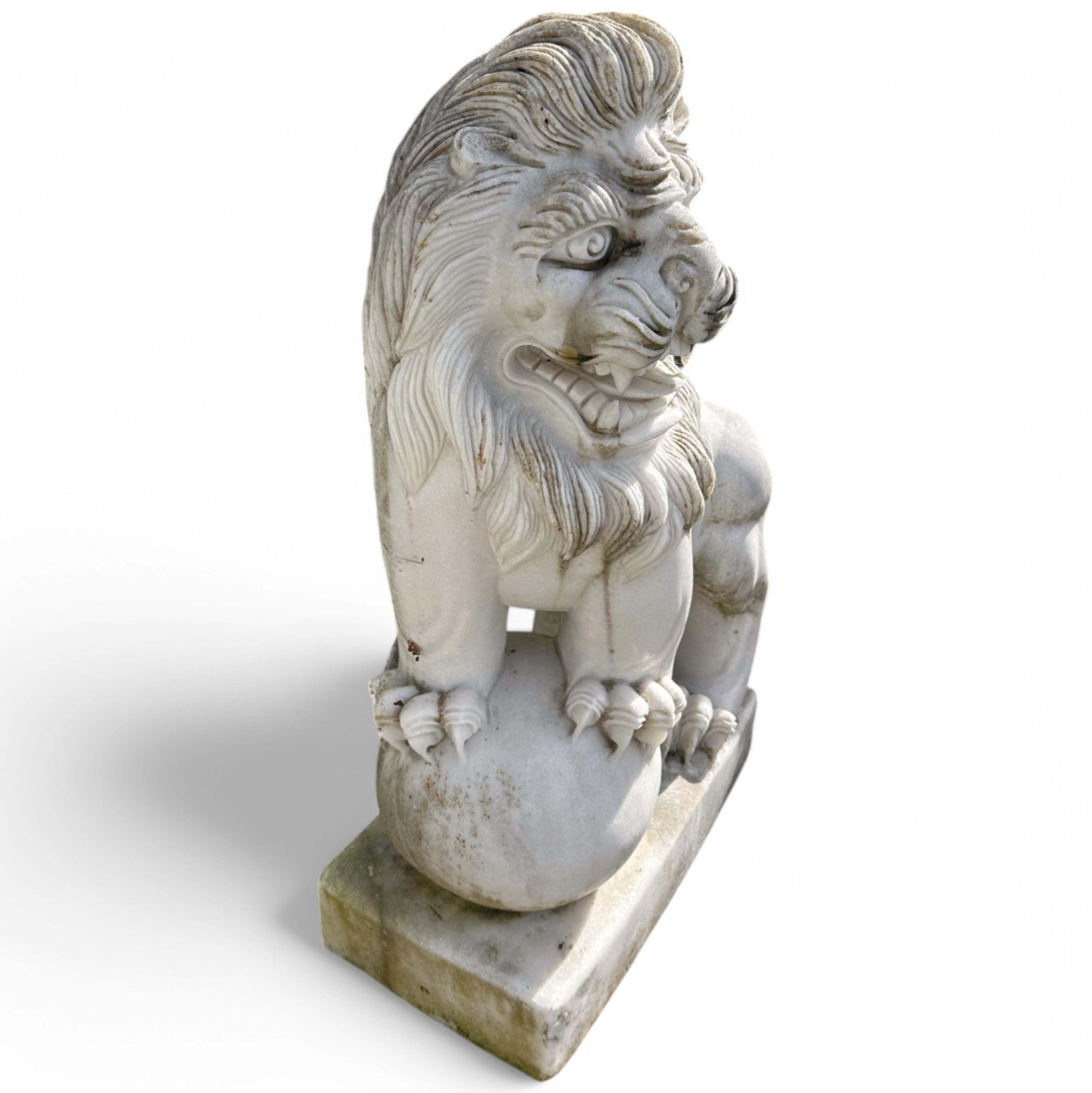 A pair of reconstituted white marble models of lions rampant
